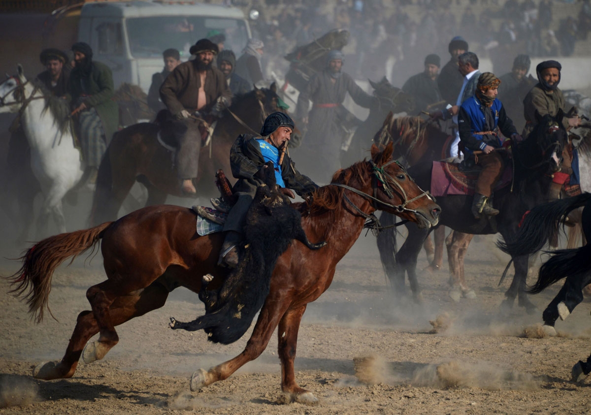 In this photograph taken on December 15, 2017, Afghan horsemen compete during a game of the traditional sport of Buzkashi in Mazar-i-Sharif.