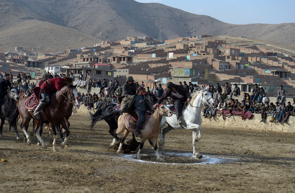 This photo taken on December 1, 2017 shows Afghan horsemen competing during a game of the traditional sport of buzkashi on the outskirts of Kabul.