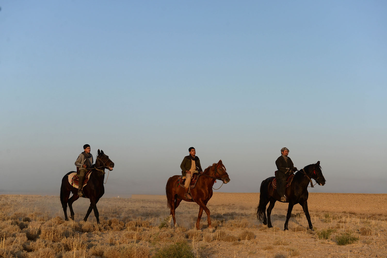 This photo taken on November 8, 2017 shows Afghan men riding horses in Mazar-i-Sharif.