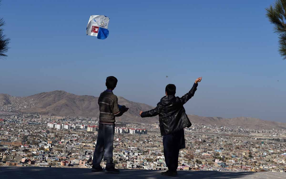 Afghan children fly kites during a kite festival at the Wazir Akbar Khan hilltop in Kabul on November 26, 2016.