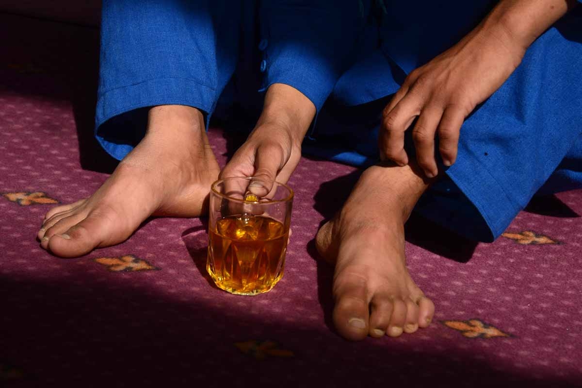 This file photo taken on October 31, 2016 shows an Afghan boy, who was held as a child sex slave, drinking tea at a restaurant in a unidentified location in Afghanistan.