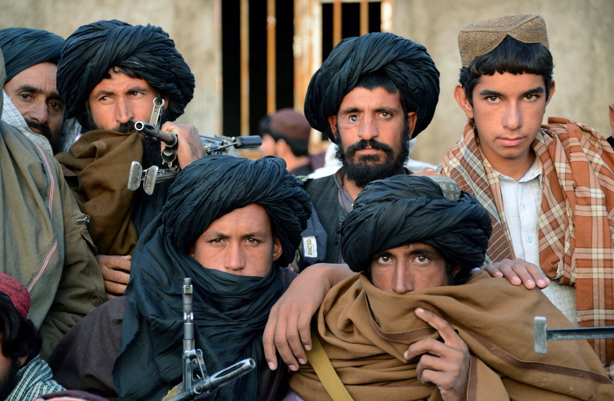 This file photo taken on November 3, 2015 shows Afghan Taliban fighters as they listen to an unseen Mullah Mohammad Rasool Akhund, the newly appointed leader of a breakaway faction of the Taliban, at Bakwah in the western province of Farah.