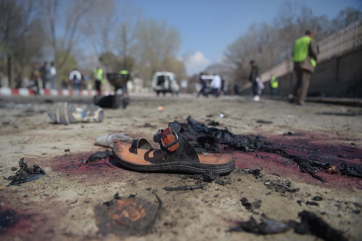 A sandal is seen laying on the ground along a road at the site of a suicide bombing attack in Kabul on March 21, 2018.