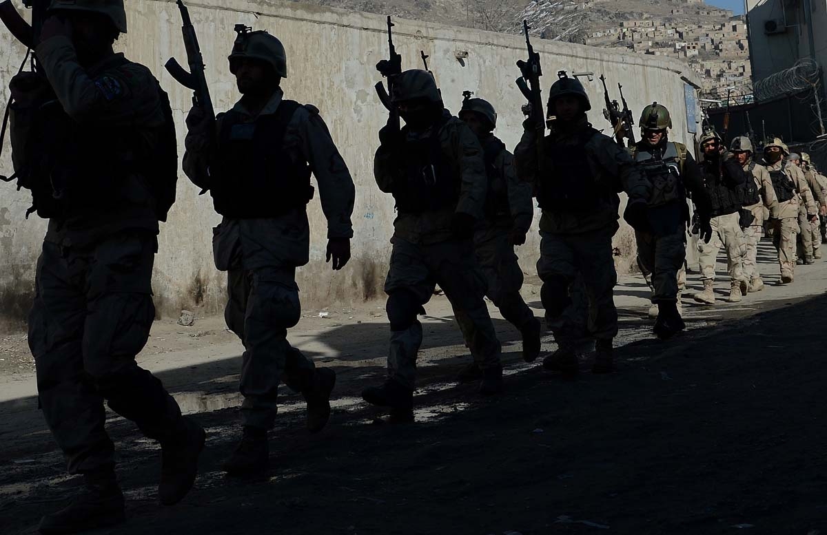 In this file photo taken on January 21, 2013 Afghan commandos walk down a road near the Kabul police headquarters building after a clash between Afghanistan forces and Taliban fighters in Kabul.