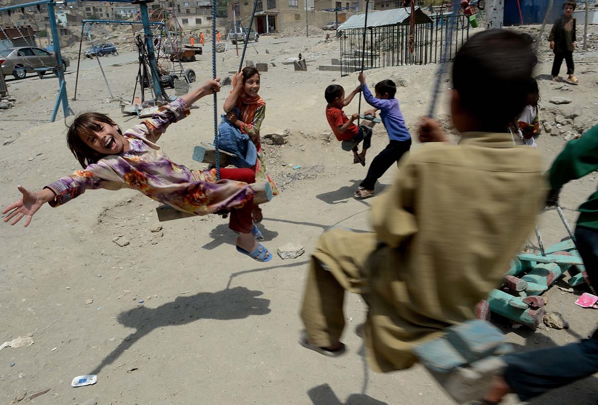 Afghan children play with plastic toy guns in Kabul on August 8, 2013. Civilian casualties in the Afghan war rose 23 percent in the first half of this year due to Taliban attacks and increased fighting between insurgents and government forces, the UN said