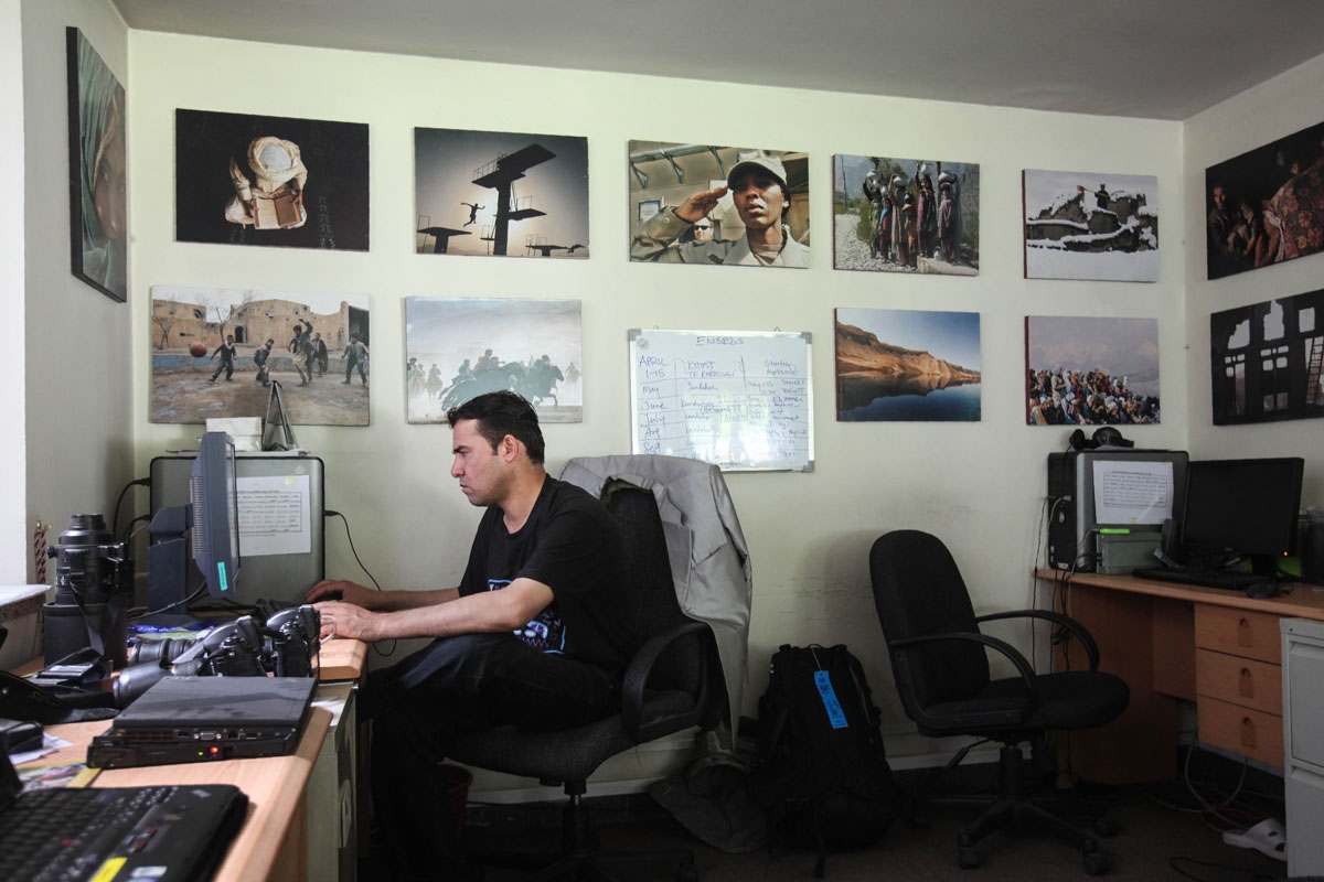 In this photo taken on June 17, 2010, Agence France-Presse (AFP) chief photographer for Afghanistan Shah Marai sits at his desk at the AFP office in Kabul.