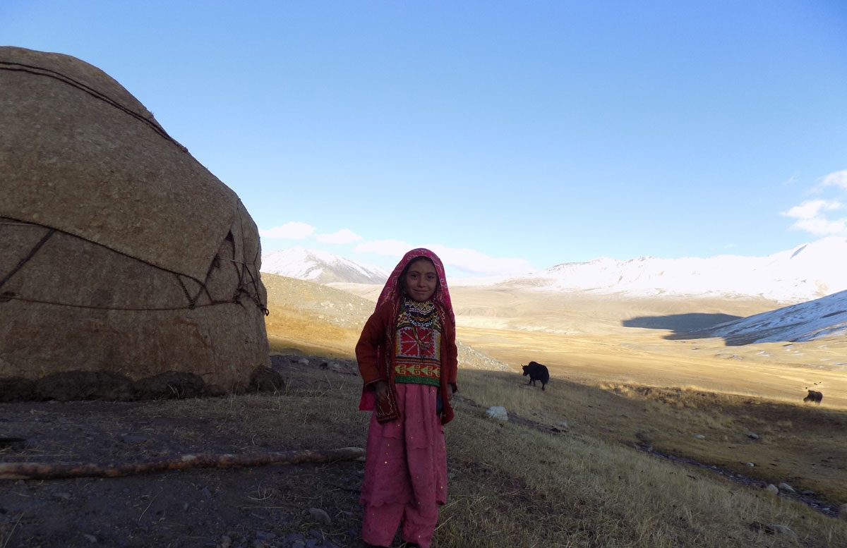 This picture taken on October 8, 2017 shows a Kyrgyz girl standing outside her traditional yurt in the Wakhan Corridor in Afghanistan.