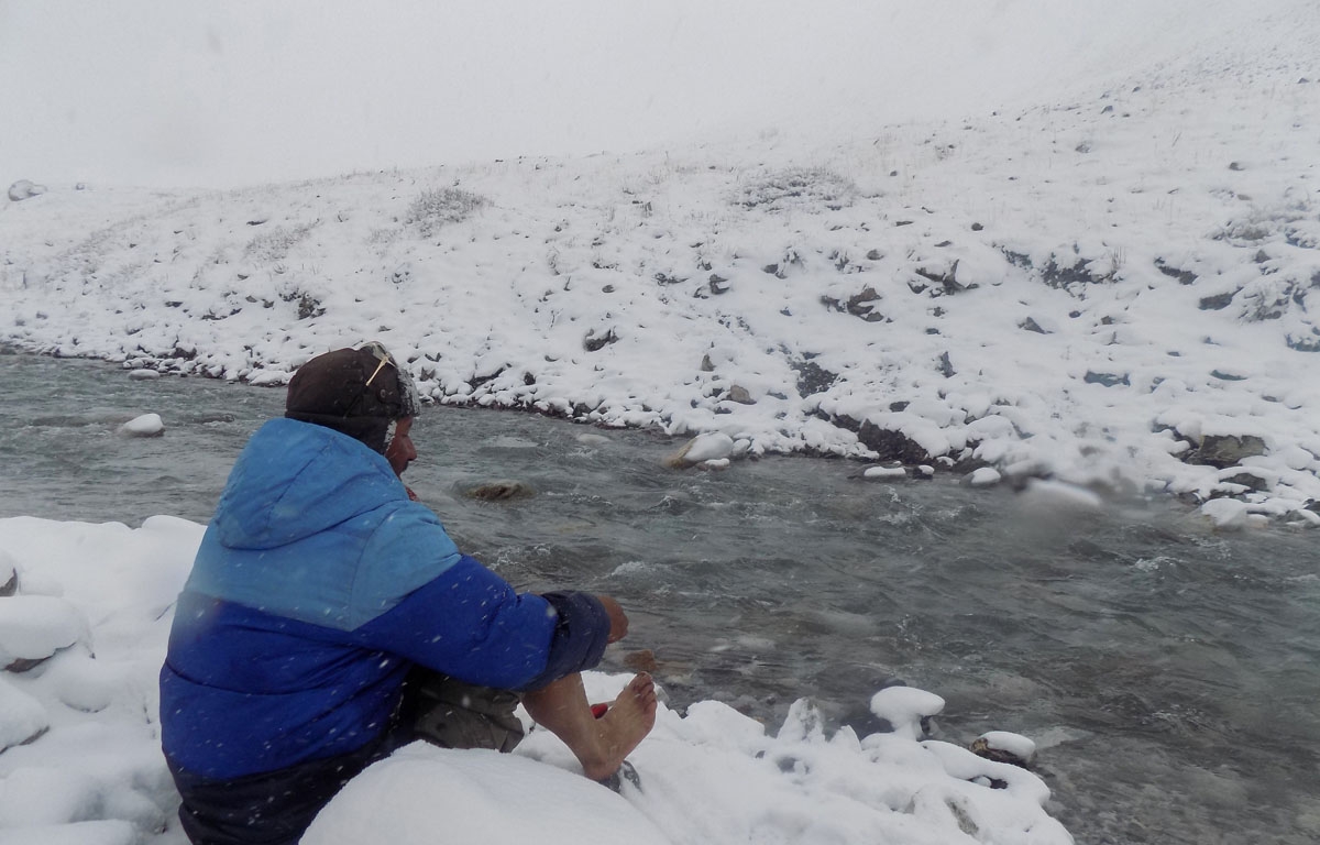 Trader Afzal Baig gets ready to cross a stream.