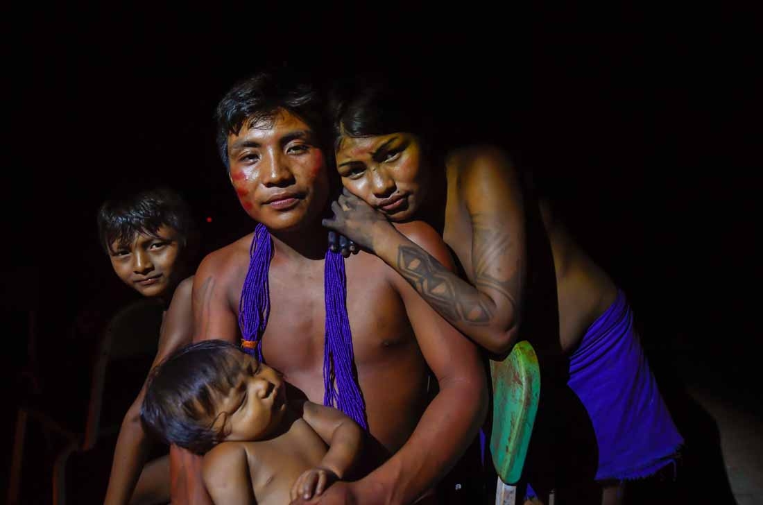 A Waiapi family poses for a picture in Waiapi indigenous reserve in Amapa state in Brazil on October 14, 2017. Tribal chieftain Tzako Waiapi perfectly remembers the day almost half a century ago when his hunting party stumbled across a group of white adv
