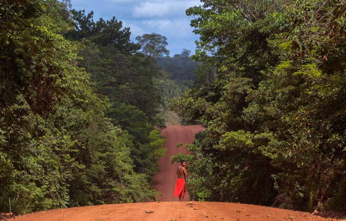 A Waiapi man walks on the road in the Waiapi indigenous reserve in Amapa state in Brazil on October 15, 2017.