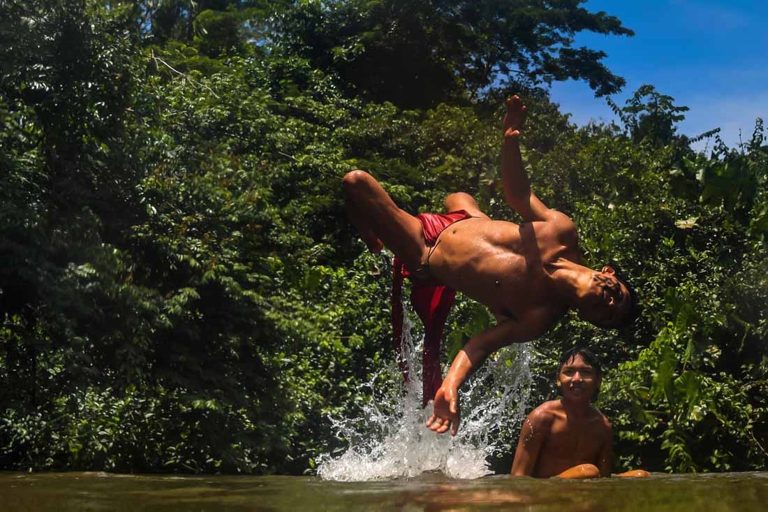 Waiapi men enjoy the Feliz river in the Waiapi indigenous reserve in Amapa state in Brazil on October 14, 2017.