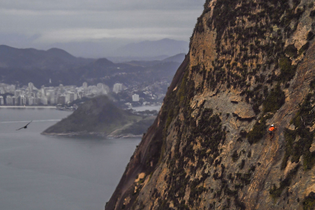 A person climbs the mountainside of Rio de Janeiro's Sugar Loaf on August 23, 2017.A person climbs the mountainside of Rio de Janeiro's Sugar Loaf on August 23, 2017.