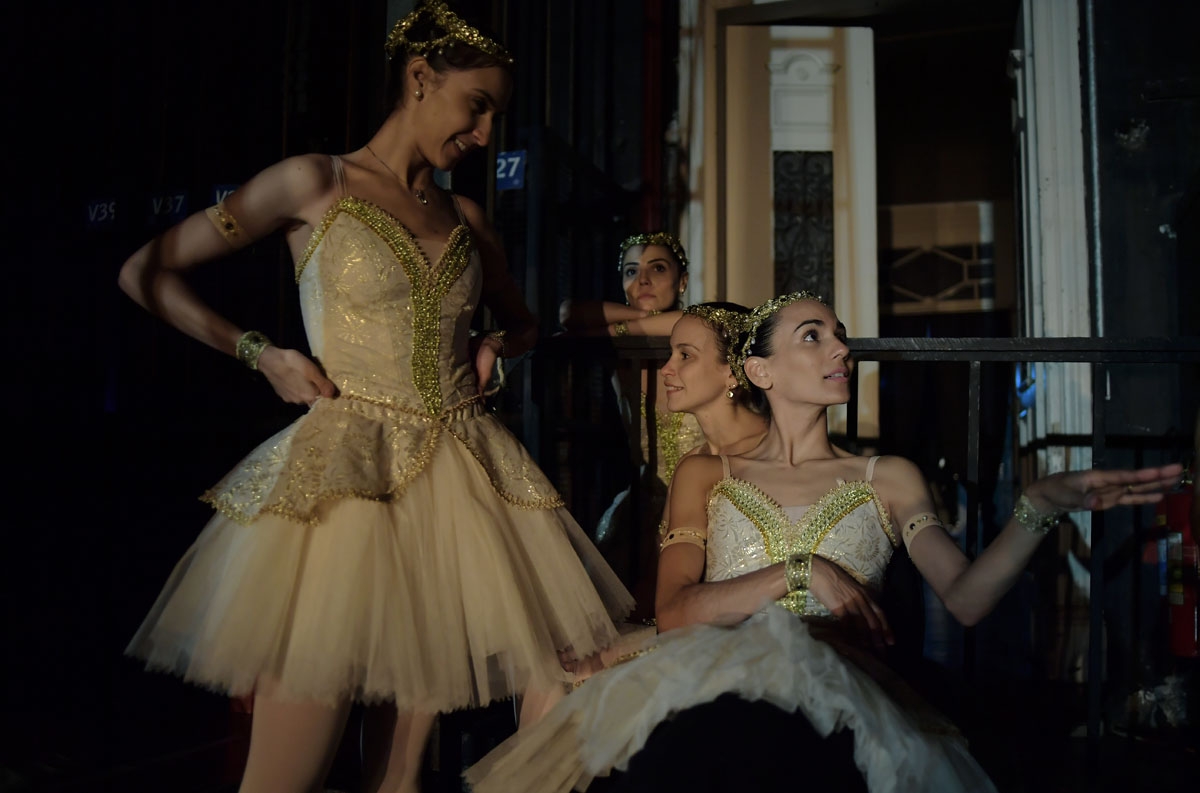 Ballet dancers sit backstage during a rehearse before the opening night of a Ballet production at the Municipal Theater in Rio de Janeiro, Brazil on June 19, 2018. -