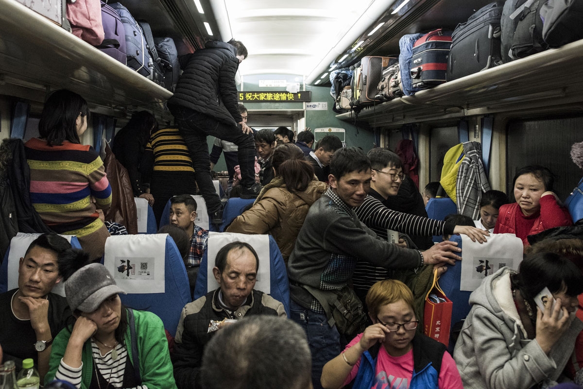 This photo taken on February 10, 2018 shows passengers travelling on a crowded train during the 26-hour journey from Beijing to Chengdu, in Shijiazhuang, as they head home ahead of the Lunar New Year.