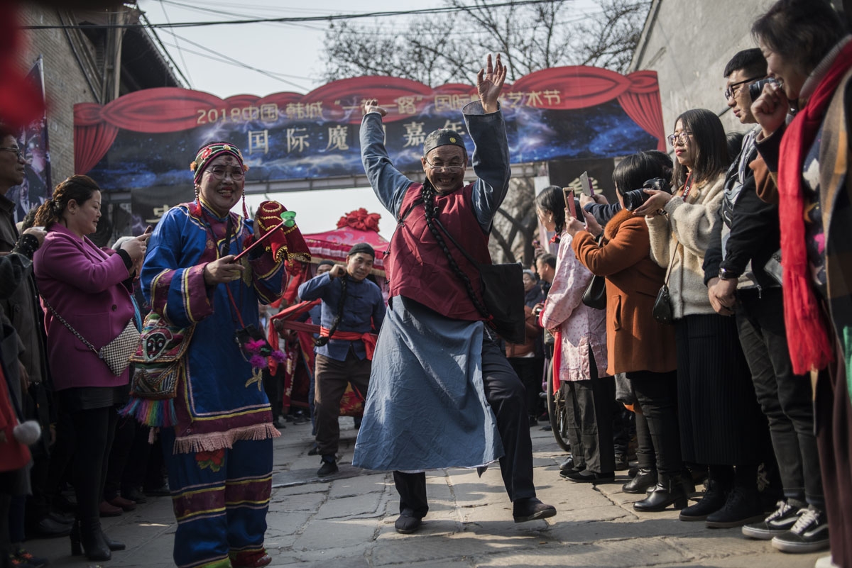 Chinese man dressed with a traditional costume, attends a wedding performance as part of the She Huo festival, to celebrate the Lunar New Year, marking the Year of the Dog, in Hancheng, Shaanxi province, on February 16, 2018.