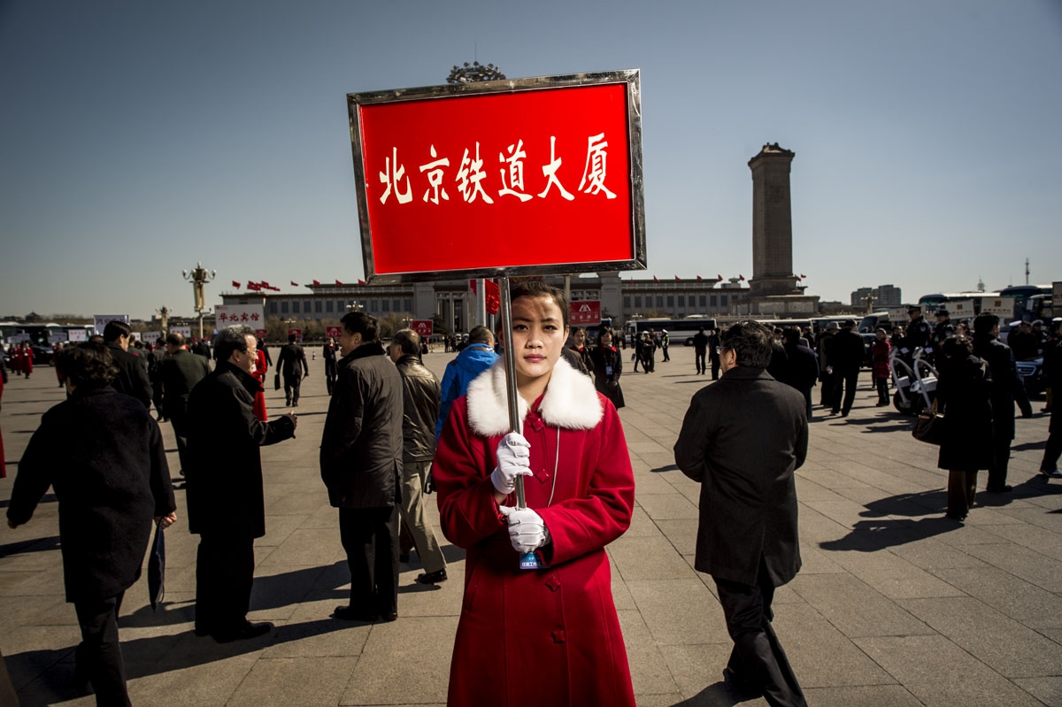 A hostess holds a hotel information board for delegates at the third plenary meeting of the Chinese People's Political Consultative Conference (CPPCC) at the Great Hall of the People in Beijing on March 11, 2016