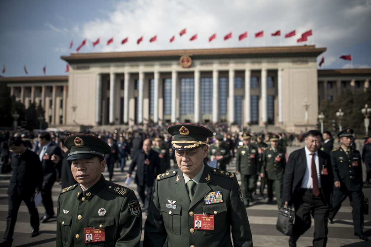 Military delegates leave the Great Hall of the People at the end of the opening of the National People's Congress in Beijing on March 5, 2017.
