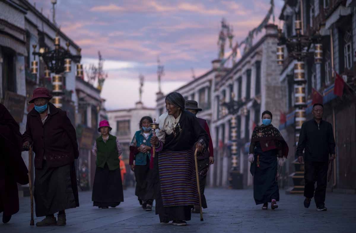 This picture taken on September 11, 2016 shows pilgrims walking and praying near the Jokhang Temple in the regional capital Lhasa, in China's Tibet Autonomous Region. This picture taken on September 11, 2016 shows pilgrims walking and praying near the Jokhang Temple in the regional capital Lhasa, in China's Tibet Autonomous Region.