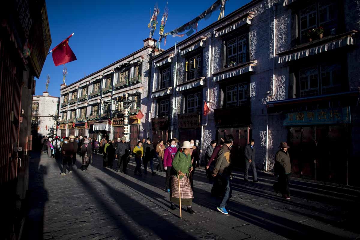This picture taken on September 10, 2016 shows a pilgrim praying and prostrating outside the Jokhang Temple in the regional capital Lhasa, in China's Tibet Autonomous Region. This picture taken on September 10, 2016 shows a pilgrim praying and prostrating outside the Jokhang Temple in the regional capital Lhasa, in China's Tibet Autonomous Region.