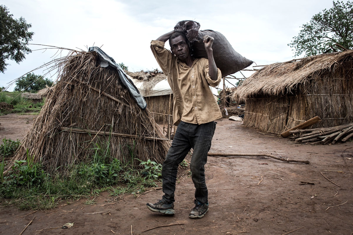 A Congolese man carries a sack inside a makeshift camp for Internally Displaced Persons (IDP's) and returnees on March 21, 2018 in Kabutunga, Democratic Republic of the Congo.