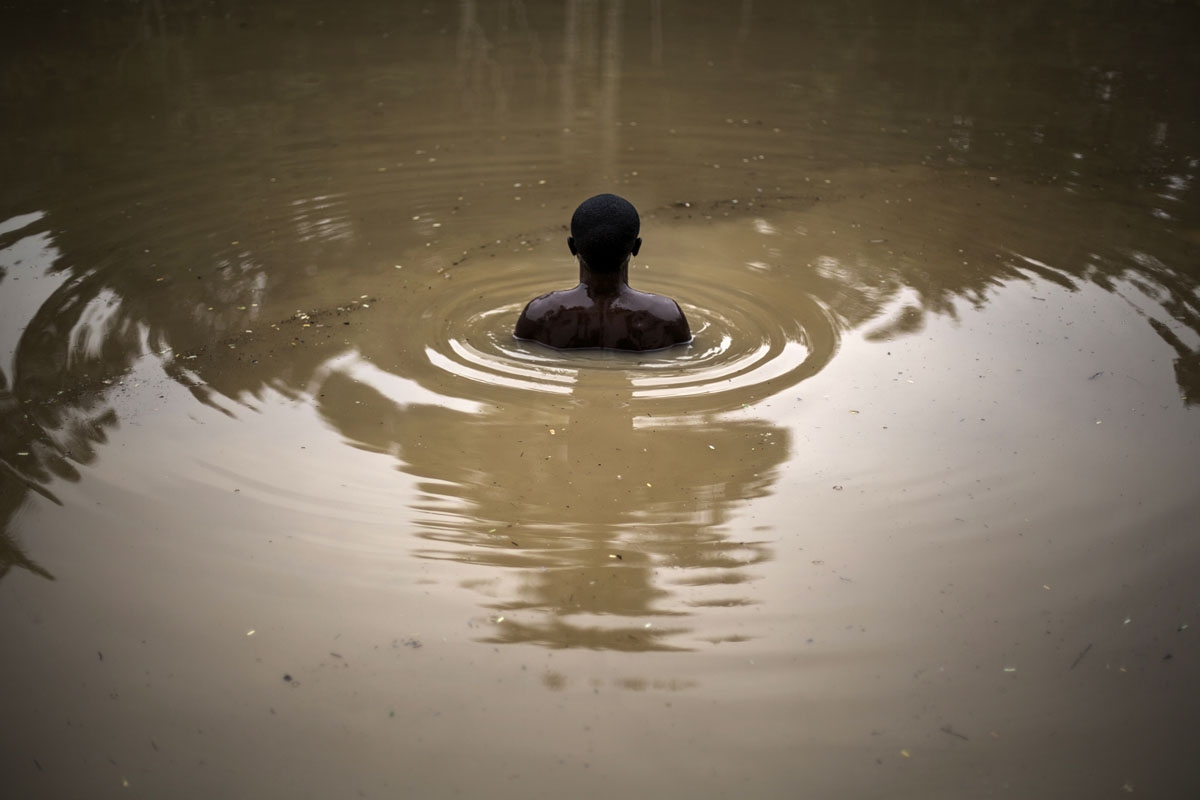  member of the Kimbanguist church submerges himself three times in the holy water to cleanse himself on May 24, 2017 in Nkamba.