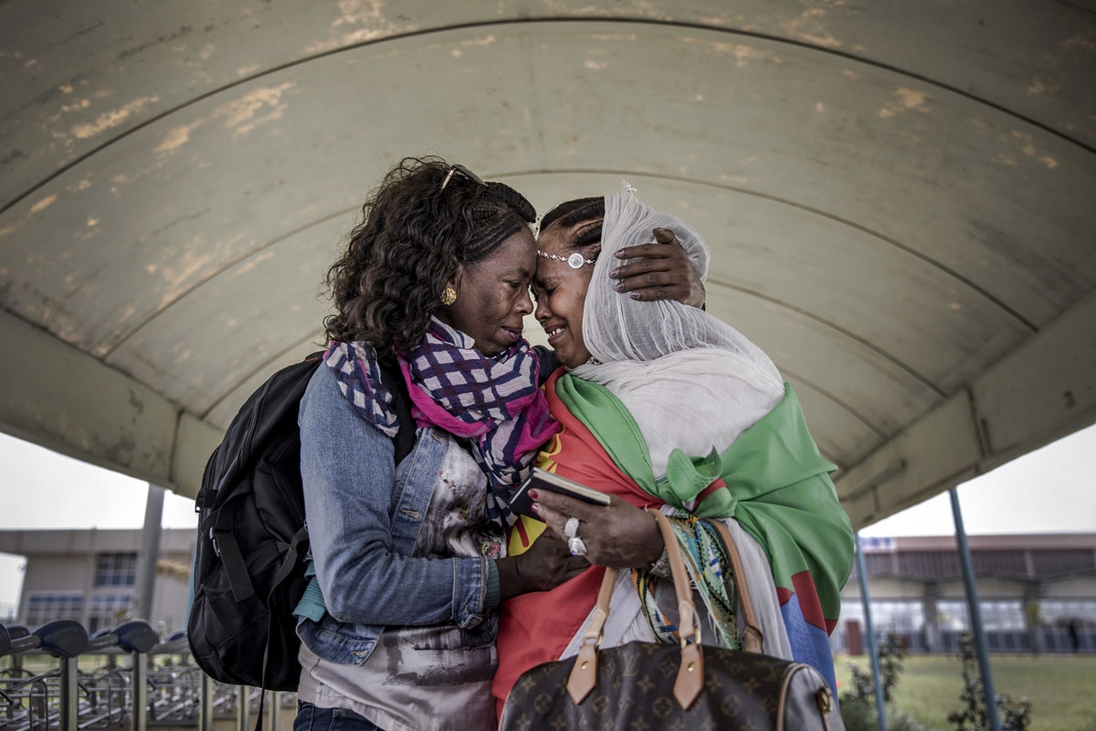 Two Eritrean sisters living in the diaspora get reunited in their home country after more than two decades without seeing each other upon the arrival of the flight from Ethiopian capital Addis Ababa at Asmara International Airport in Asmara, Eritrea on Ju