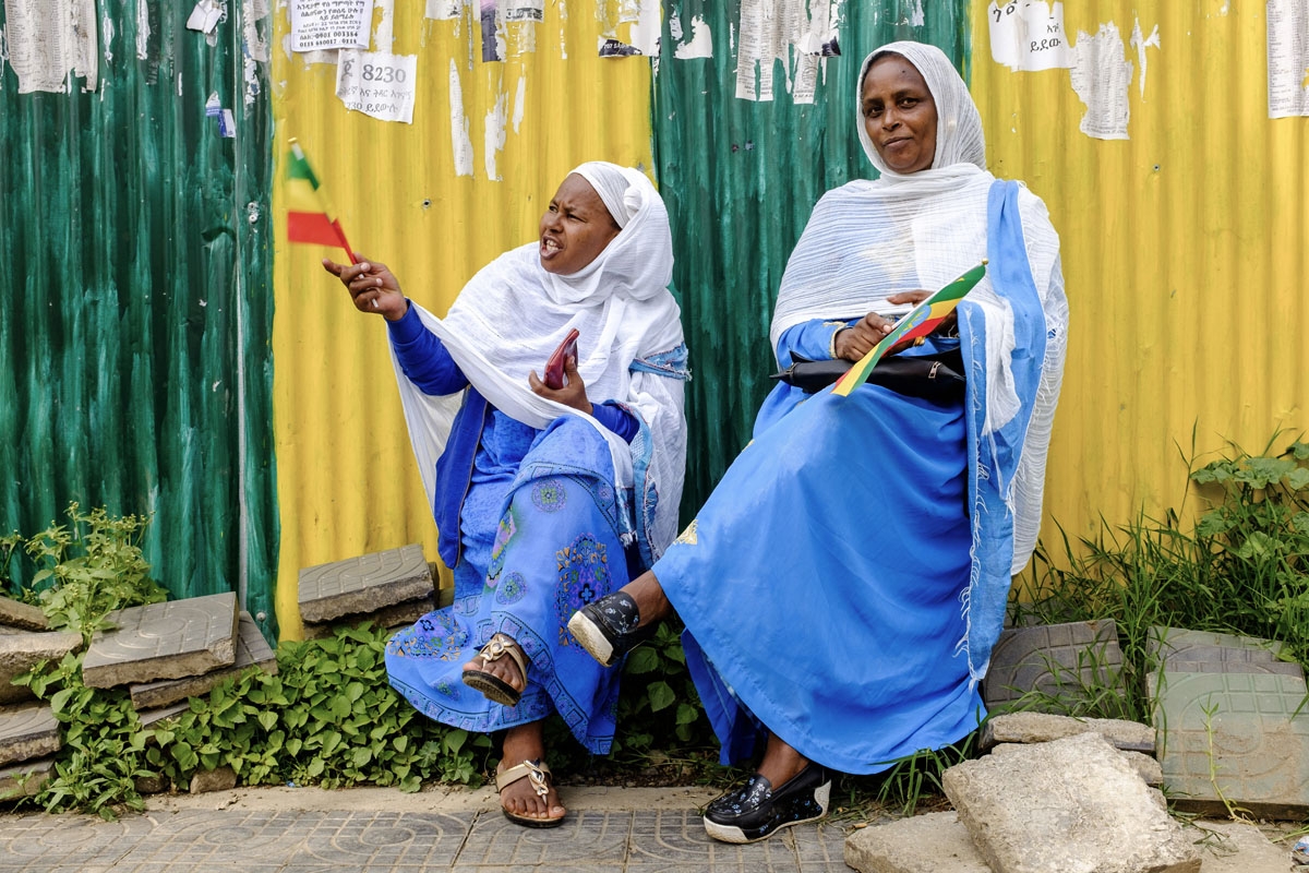 Women hold flags of Ethiopia to celebrate the arrival of Eritrean President in Addis Ababa on July 14, 2018.