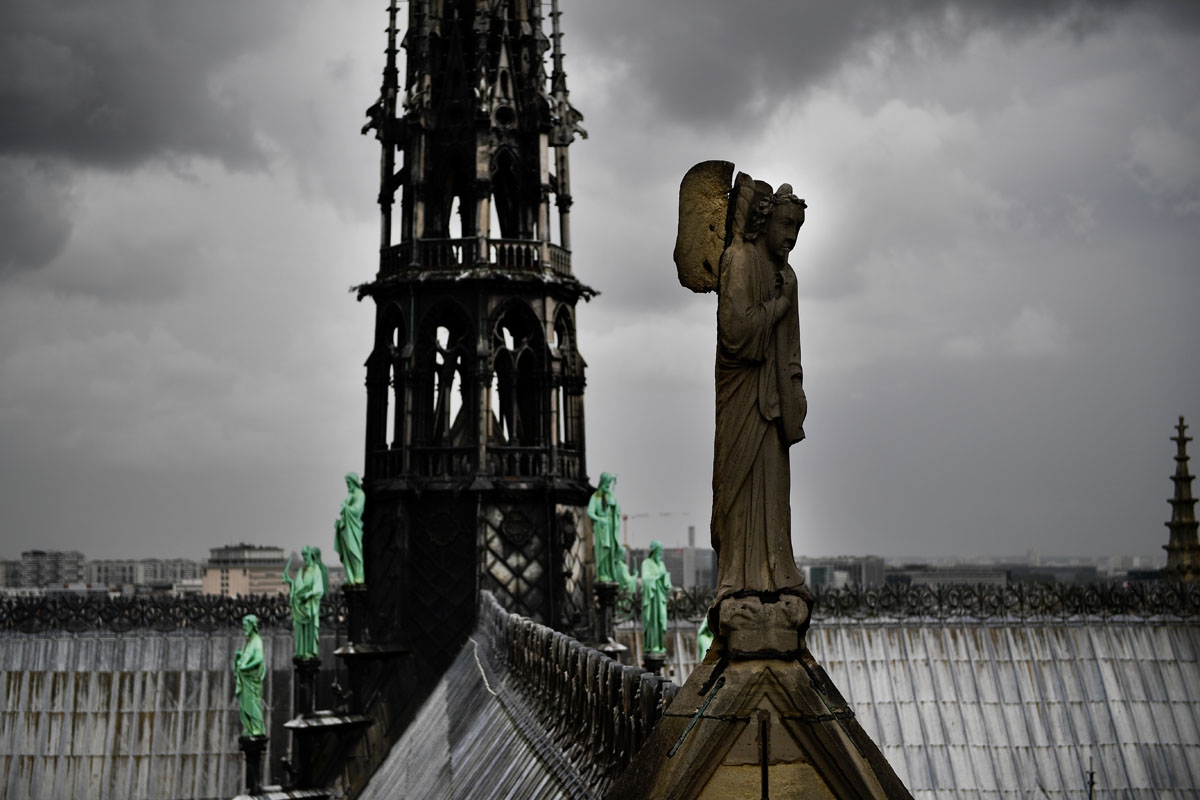 A picture taken on June 28, 2017 shows a statue on the roof of Notre-Dame cathedral in Paris, as the monument needs a huge restoration.