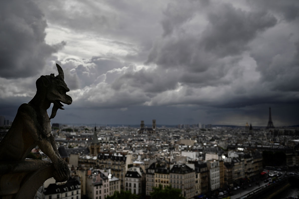 A picture taken on June 28, 2017 shows gargoyles on the roof of Notre-Dame cathedral in Paris, as the monument needs a huge restoration. / AFP PHOTO / Martin BUREAU