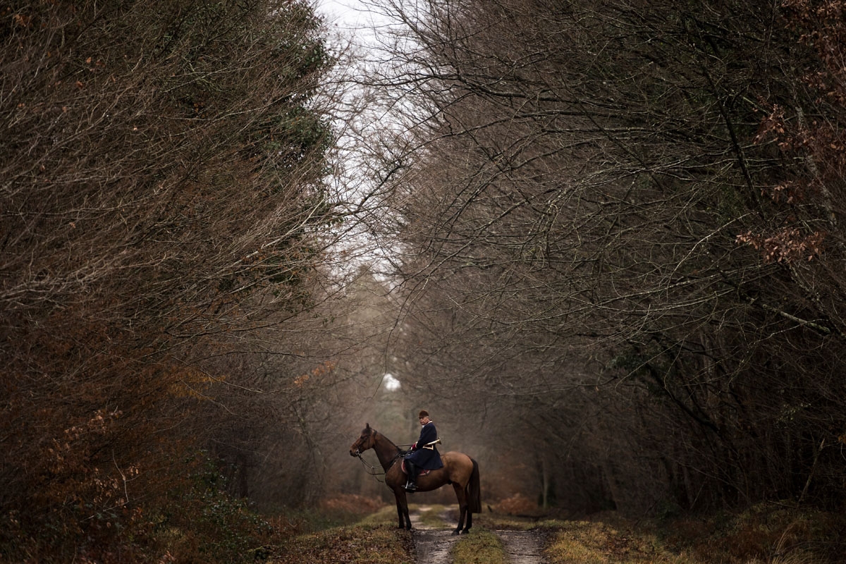 A hunter rides his horse during a hunting with hounds on December 23, 2017 in the forest near Chatenoy, center France.