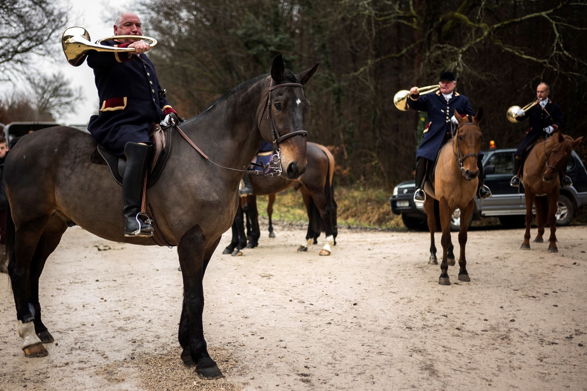 Pierre-Francois Prioux (L), founder of the Rallye Tempete rides his horse during a hunting with hounds on December 23, 2017 in the forest near Chatenoy, center France.
