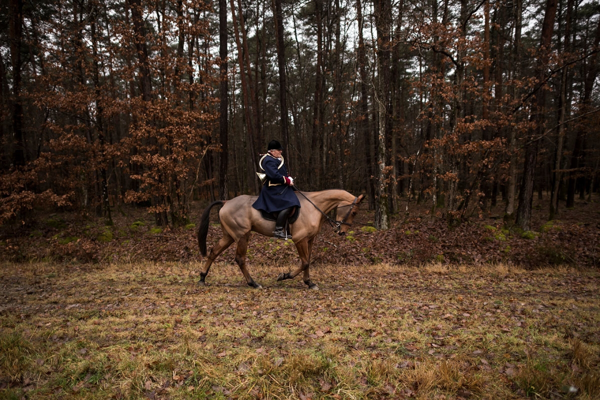 A hunter rides his horse during a hunting with hounds on December 23, 2017 in the forest near Chatenoy, center France.