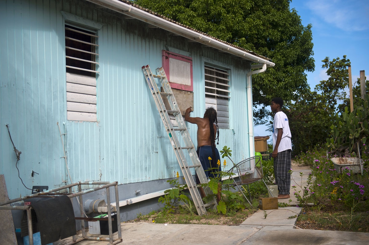 People put boards on their windows as part of preparations for arrival of Hurricane Irma on September 5, 2017 in Marigot, on the French overseas island of Saint-Martin.