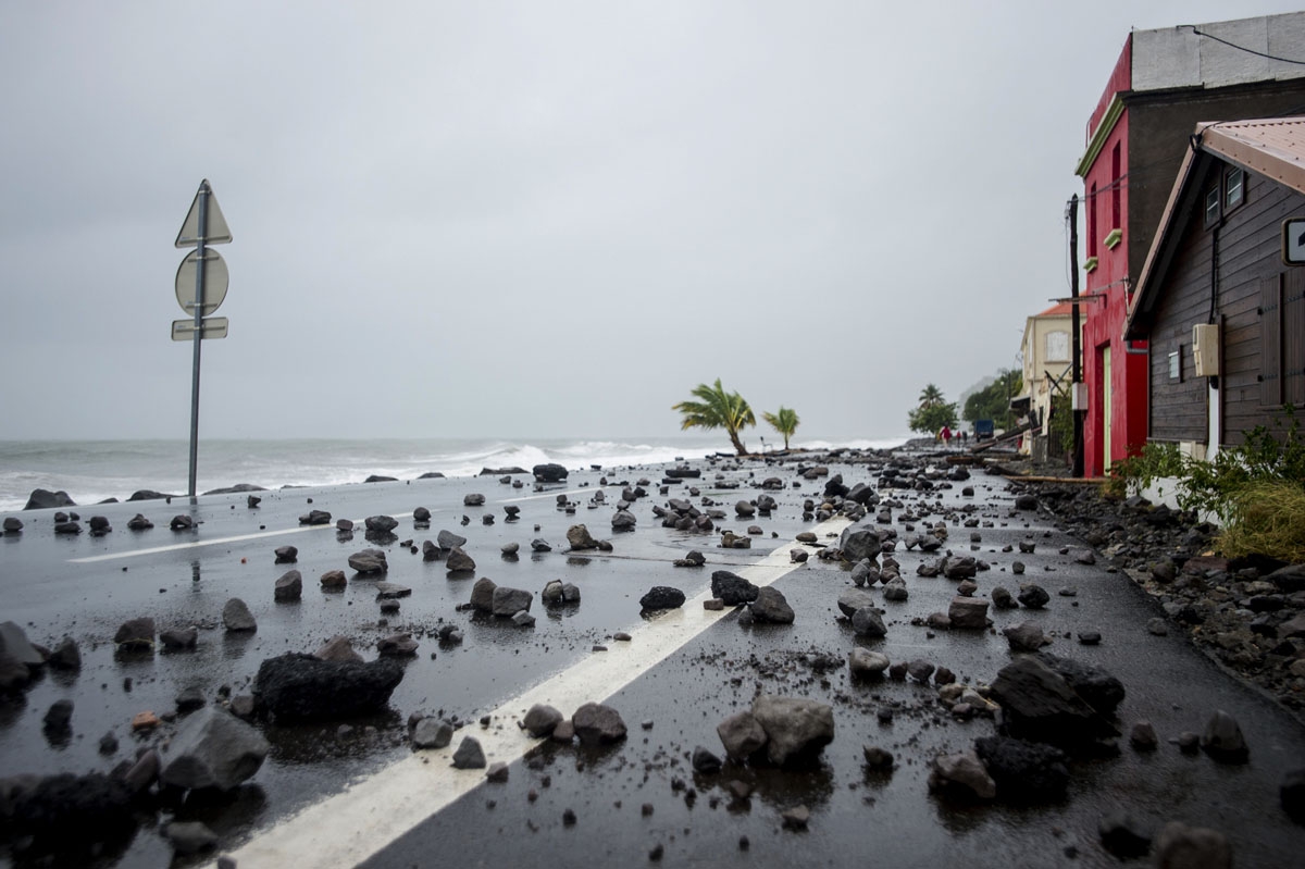 A picture shows rocks swept by strong waves onto a road in Le Carbet, on the French Caribbean island of Martinique, after it was hit by Hurricane Maria, on September 19, 2017.