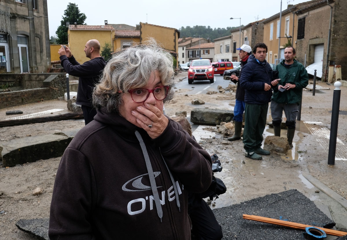 A woman discovers the damages in a street of Villegailhenc in the Aude department after it was particularly badly hit by heavy rain storms which swamped parts of southwestern France, flooding rivers and cutting roads, killing at least six people. - The Au