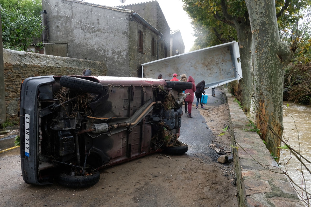 A photo taken on October 15, 2018 shows a damaged car by the Trapel river following heavy rains that saw rivers bursting banks on October 15, 2018 in Villegailhenc, near Carcassone, southern France.