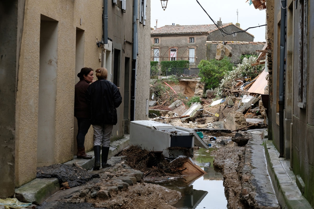 Residents look at the damaged on October 15, 2018 in Villegailhenc, after flash floods swamped a number of towns and villages around the fortress city of Carcassonne, southern France. - A