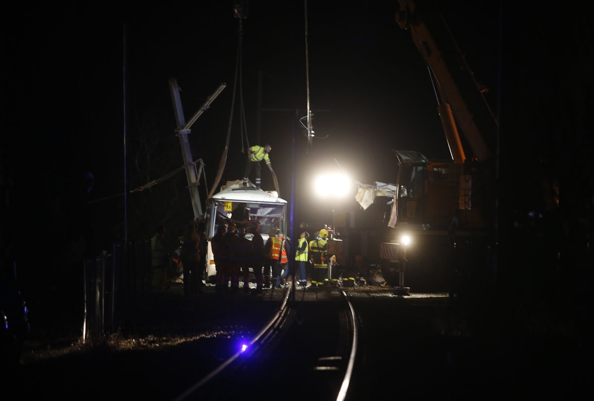 Firefighters and police work at the site of an accident in Millas, near Perpignan, southern France, on December 14, 2017, after a train crashed into a school bus at a level crossing.