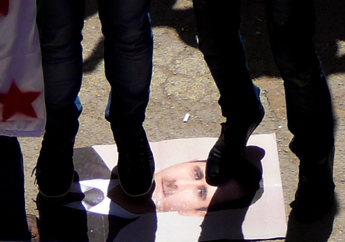 n image released by the Syrian opposition's Shaam News Network, shows Syrian protesters step on a portrait of President Bashar al-Assad during an anti-regime demonstration in the town of Dael in Daraa province on May 4, 2012. n image released by the Syrian opposition's Shaam News Network, shows Syrian protesters step on a portrait of President Bashar al-Assad during an anti-regime demonstration in the town of Dael in Daraa province on May 4, 2012.