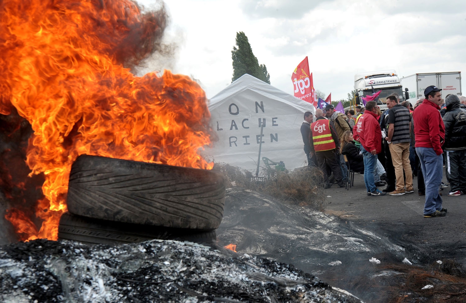 French union members burn tires as they protest against the proposed government labour reforms outside a petrol depot at Douchy-Les-Mines, northern France, on May 24, 2016 French union members burn tires as they protest against the proposed government labour reforms outside a petrol depot at Douchy-Les-Mines, northern France, on May 24, 2016