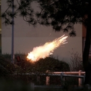 A man holds a firework in Bobigny, northern Paris, on February 16, 2017 during a demonstration to demand justice for Theo, a 22-year-old youth worker who required surgery after his arrest last week in the gritty suburb of Aulnay-sous-Bois.