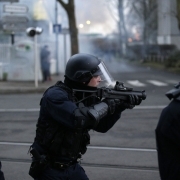 An anti riot policeman points a flashball as people gather in Bobigny, northern Paris, on February 16, 2017 during a demonstration to demand justice for Theo, a 22-year-old youth worker who required surgery after his arrest last week in the gritty suburb