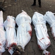 Bodies of victims from an airstrike on the Maadi neighbourhood of the northern Syrian city of Aleppo are seen on the ground wrapped in shrouds on December 17, 2013. It was the third straight day of air raids on the city, Syria's commercial hub before a re