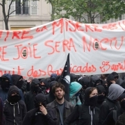 People hold a banner reading "Against the ballot box misery, our joy will be nocturnal" during a demonstration for a "social first round" of the French presidential election on April 22, 2017 on the place de la Republique in Paris. France was on edge on A