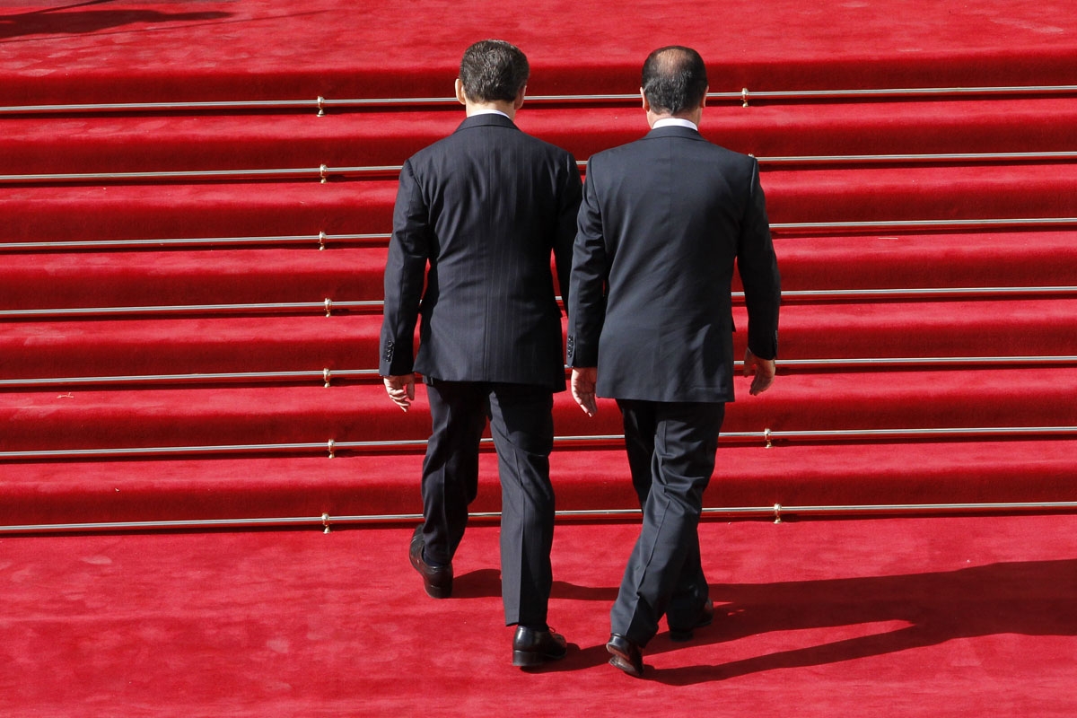 France's president Nicolas Sarkozy (L) welcomes his successor Francois Hollande upon his arrival at the Elysee Palace for the formal investiture ceremony between France's president Francois Hollande and his predecessor Nicolas Sarkozy, at the Elysee presi