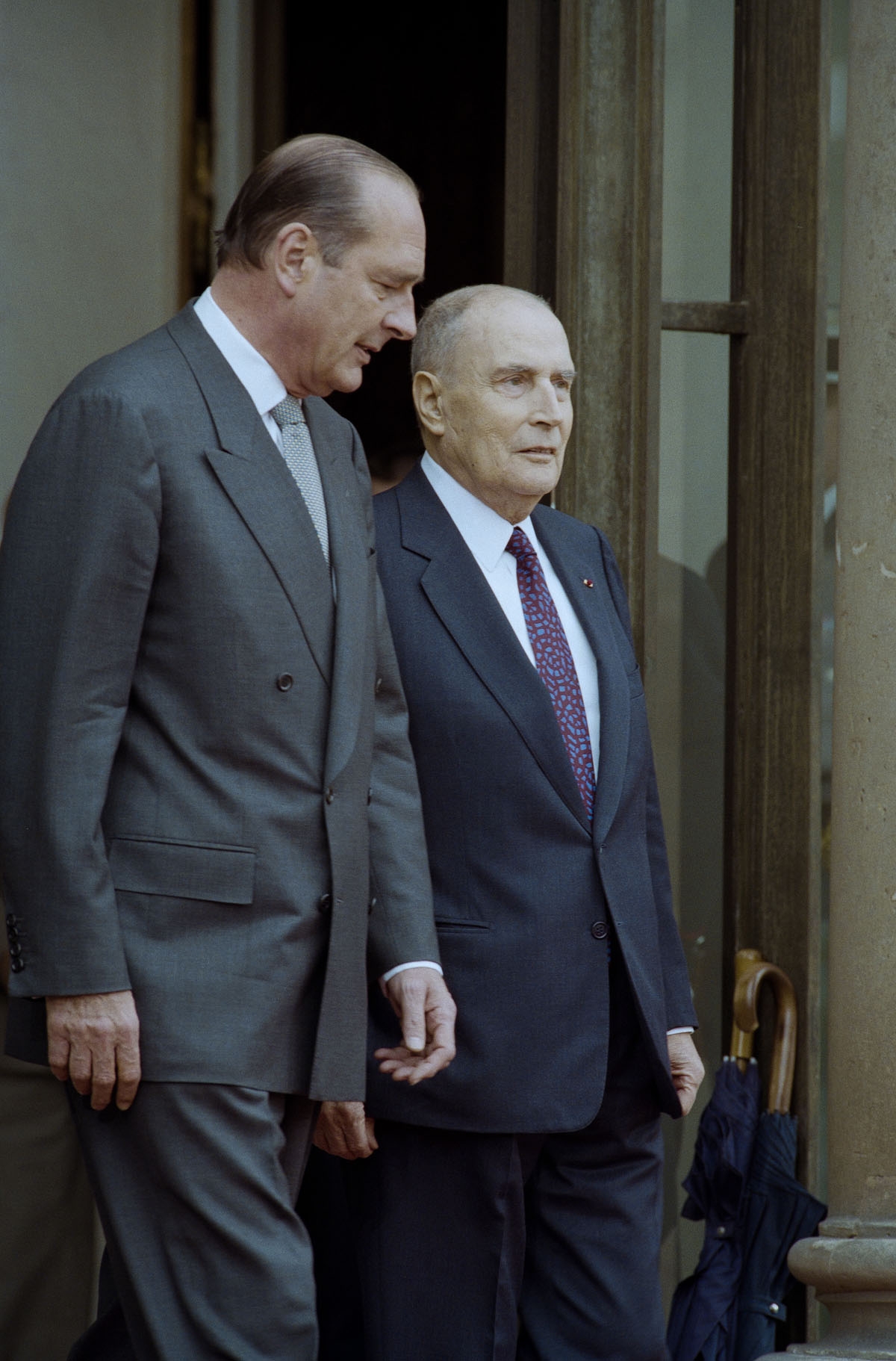 . France's President-elect Jacques Chirac (L) goes with his predecessor François Mitterrand on the doorstep at the Elysee Palace during the formal handover of power ceremony on May 17, 1995 in Paris.