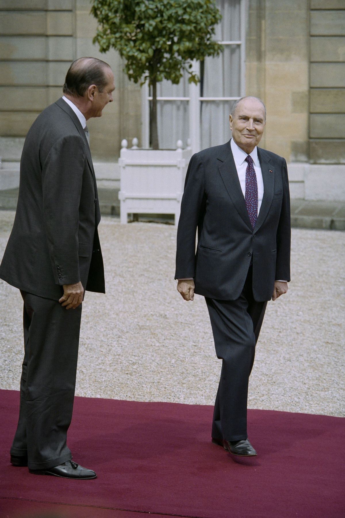 French outgoing President Francois Mitterrand (R) is escorted by his successor Jacques Chirac as he leaves the Elysee Palace during the formal handover of power ceremony on May 17, 1995 in Paris.