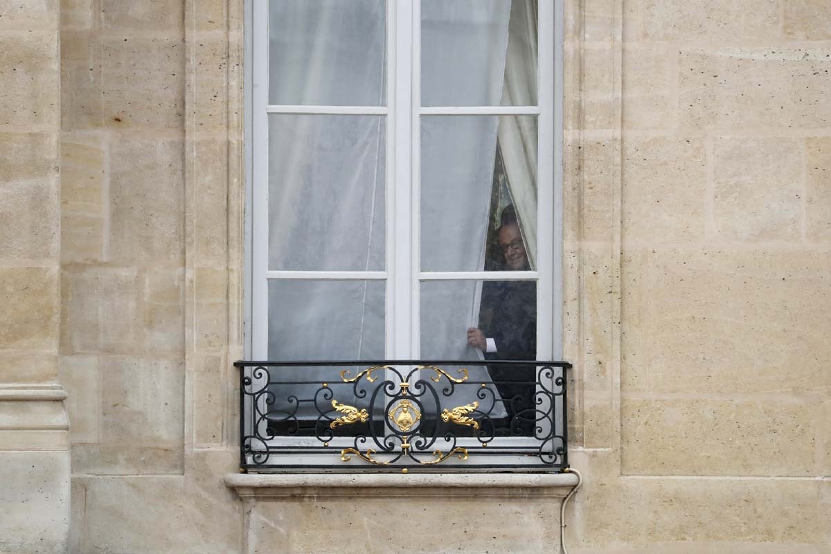 French outgoing president Francois Hollande looks out from a window of the Elysee presidential Palace prior to his successor's formal inauguration ceremony as French President on May