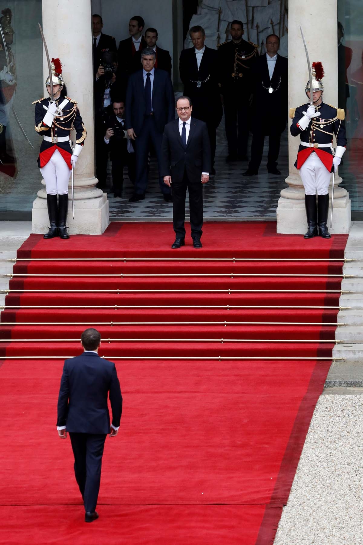 French newly elected President Emmanuel Macron is welcomed by his predecessor Francois Hollande (top C) as he arrives at the Elysee presidential Palace for the handover and inauguration ceremonies on May 14, 2017 in Paris.