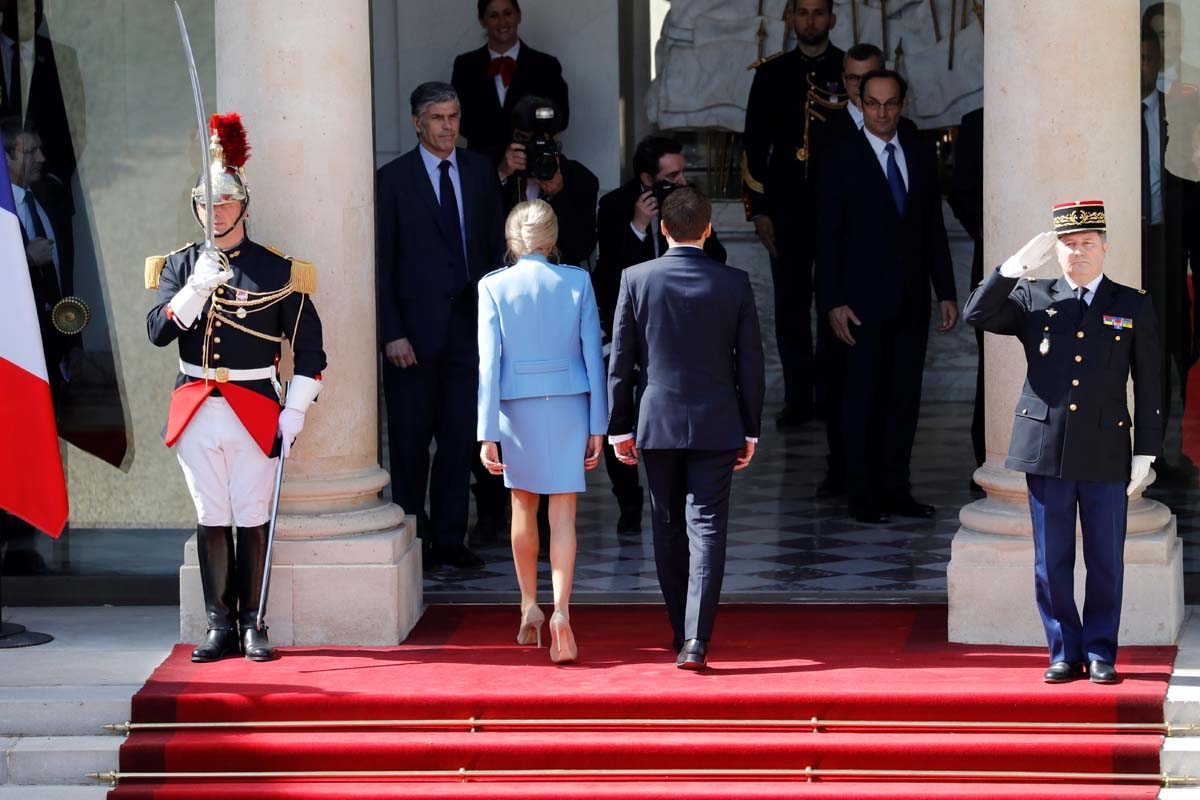 French newly elected President Emmanuel Macron (R) walks next to his wife with his wife Brigitte Trogneux at the Elysee presidential Palace before his formal